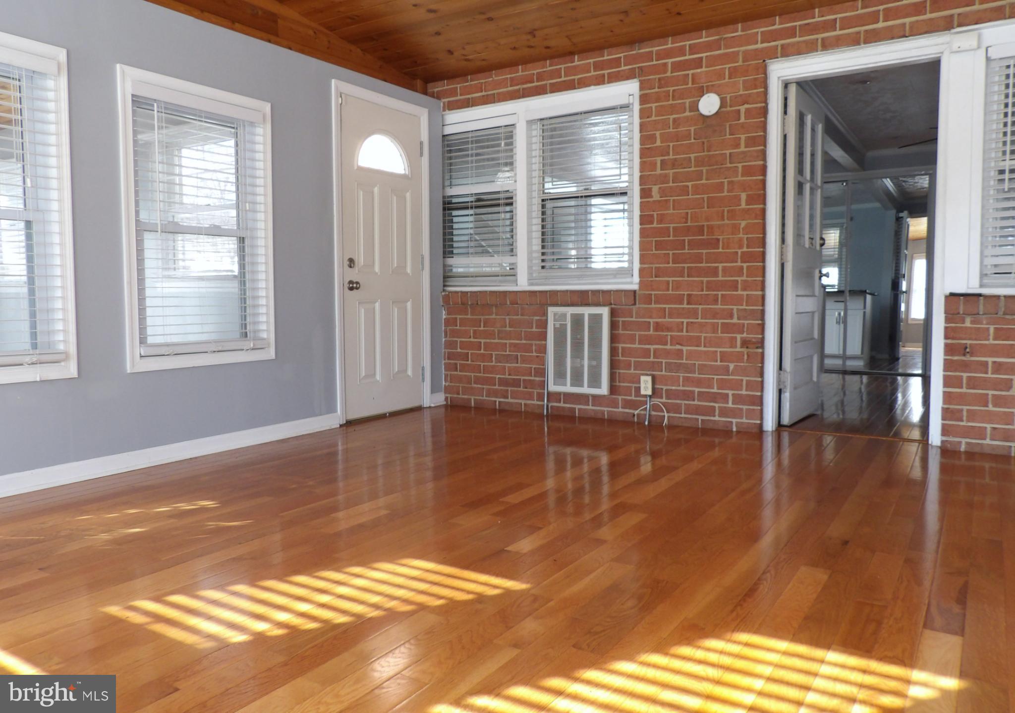 901 Grovehill Road Baltimore, MD 21227 - Photo 36 of 49 a view of a livingroom with wooden floor and a window