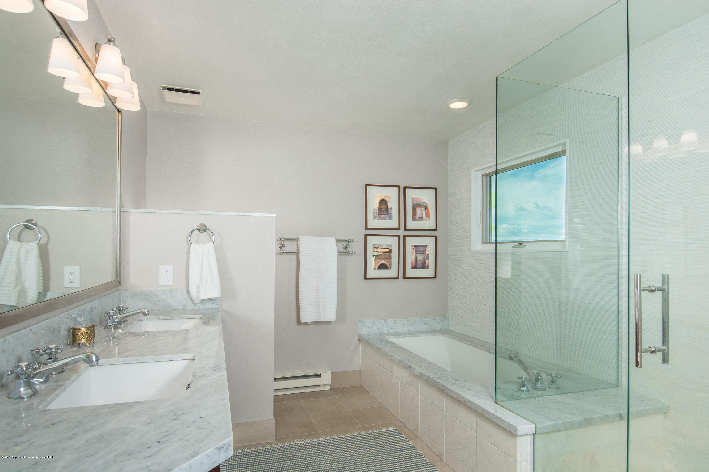 321 Mountain View Road Carbondale, CO 81623 - Photo 13 of 36 a bathroom with a granite countertop sink a mirror and a bathtub
