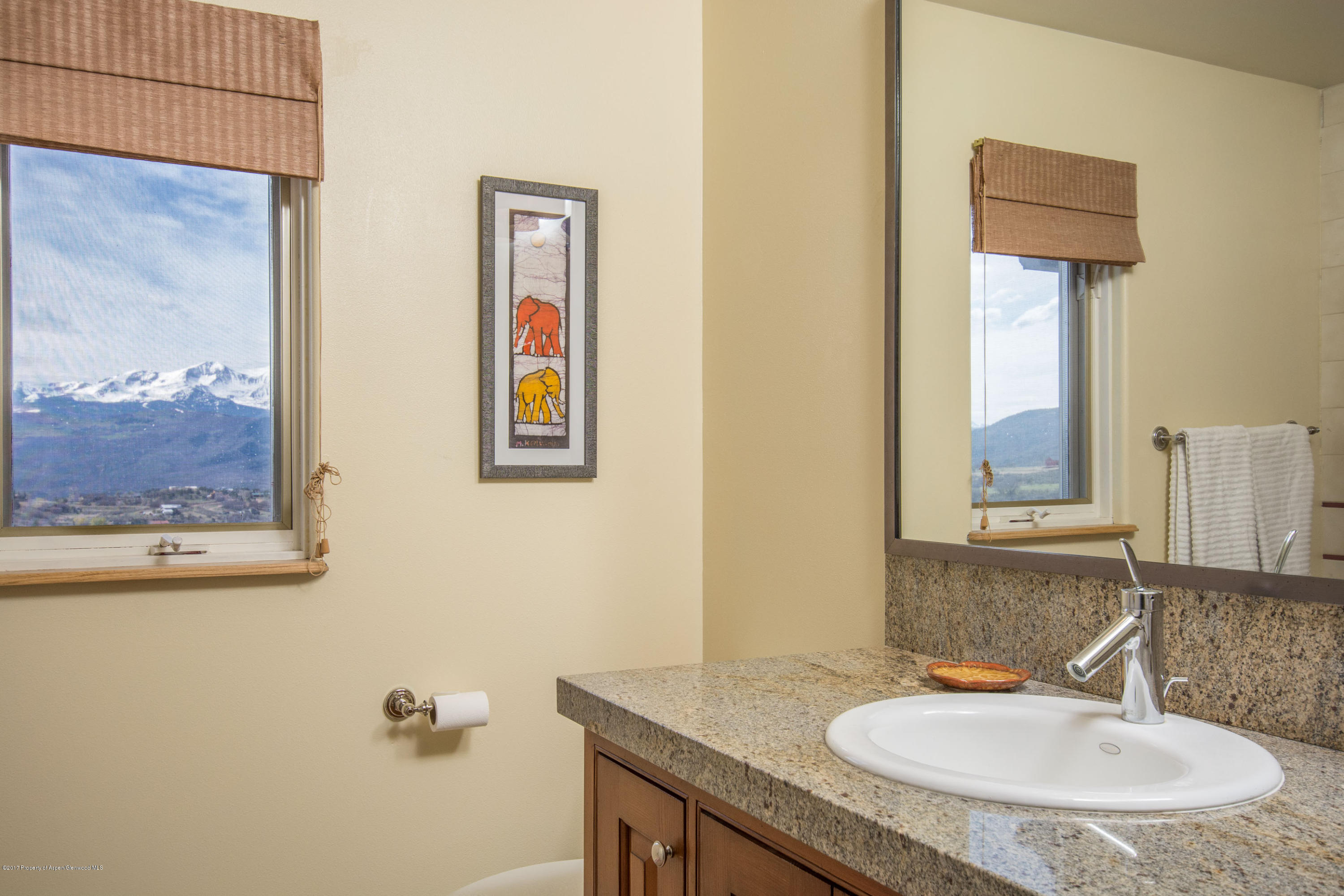 321 Mountain View Road Carbondale, CO 81623 - Photo 16 of 36 a bathroom with a granite countertop sink and a mirror