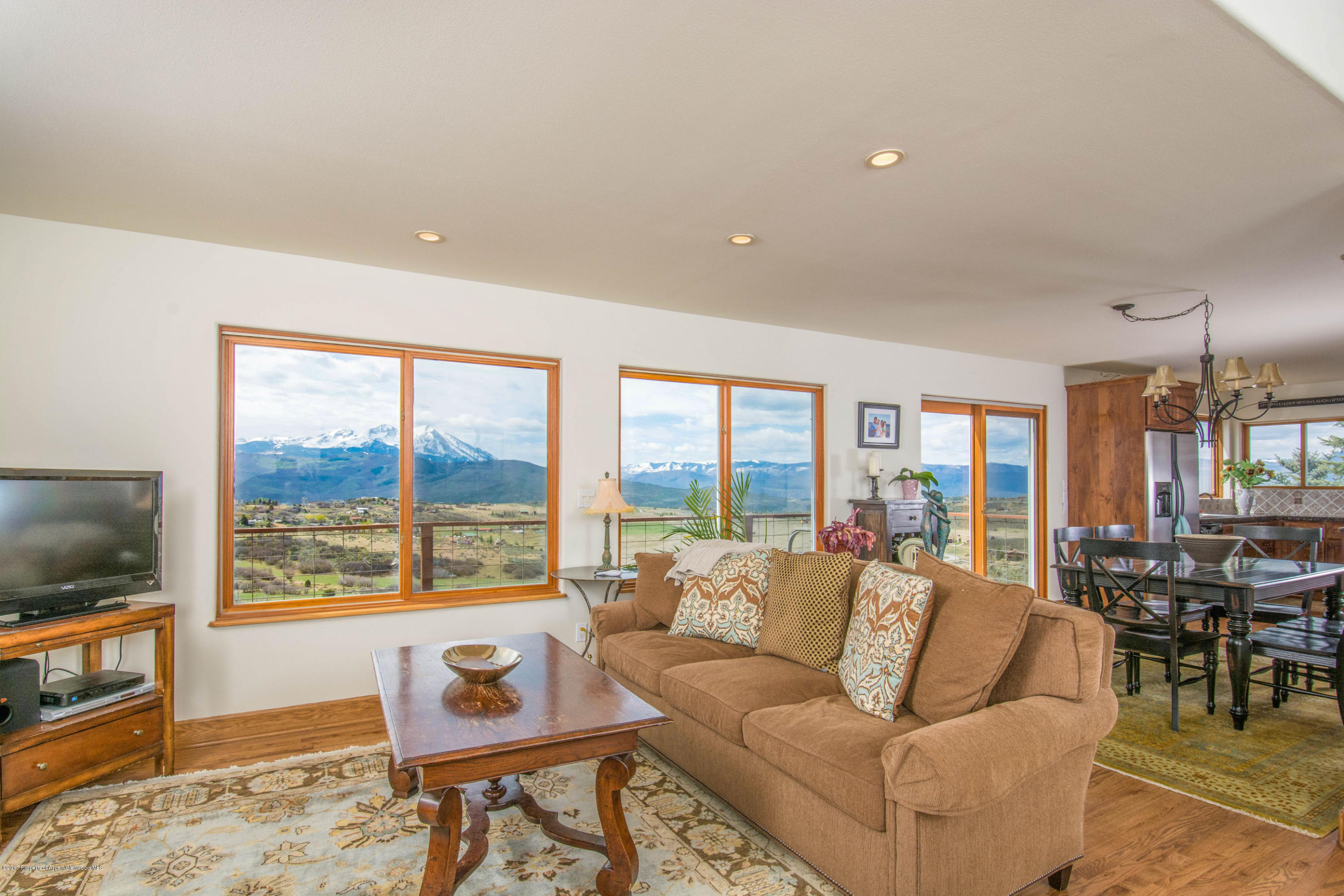 321 Mountain View Road Carbondale, CO 81623 - Photo 3 of 36 a living room with furniture and a flat screen tv next to a large window