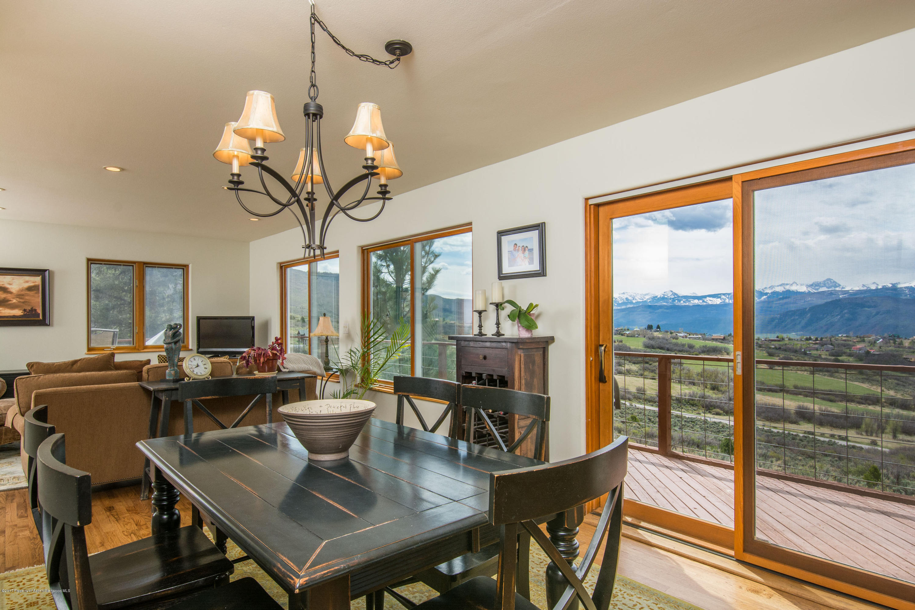 321 Mountain View Road Carbondale, CO 81623 - Photo 5 of 36 a view of a dining room with furniture large windows and wooden floor