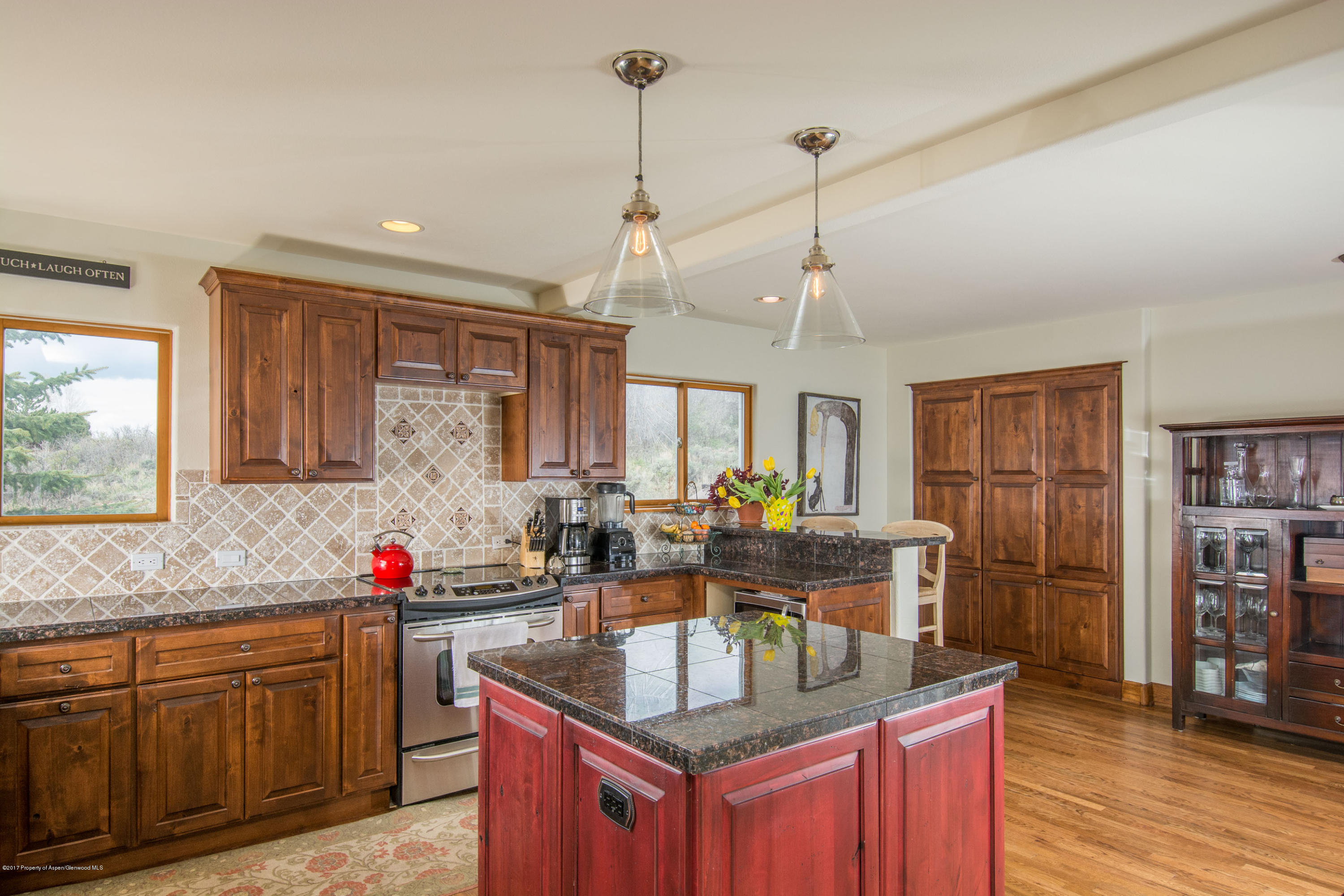 321 Mountain View Road Carbondale, CO 81623 - Photo 6 of 36 a kitchen with granite countertop a sink stove and cabinets