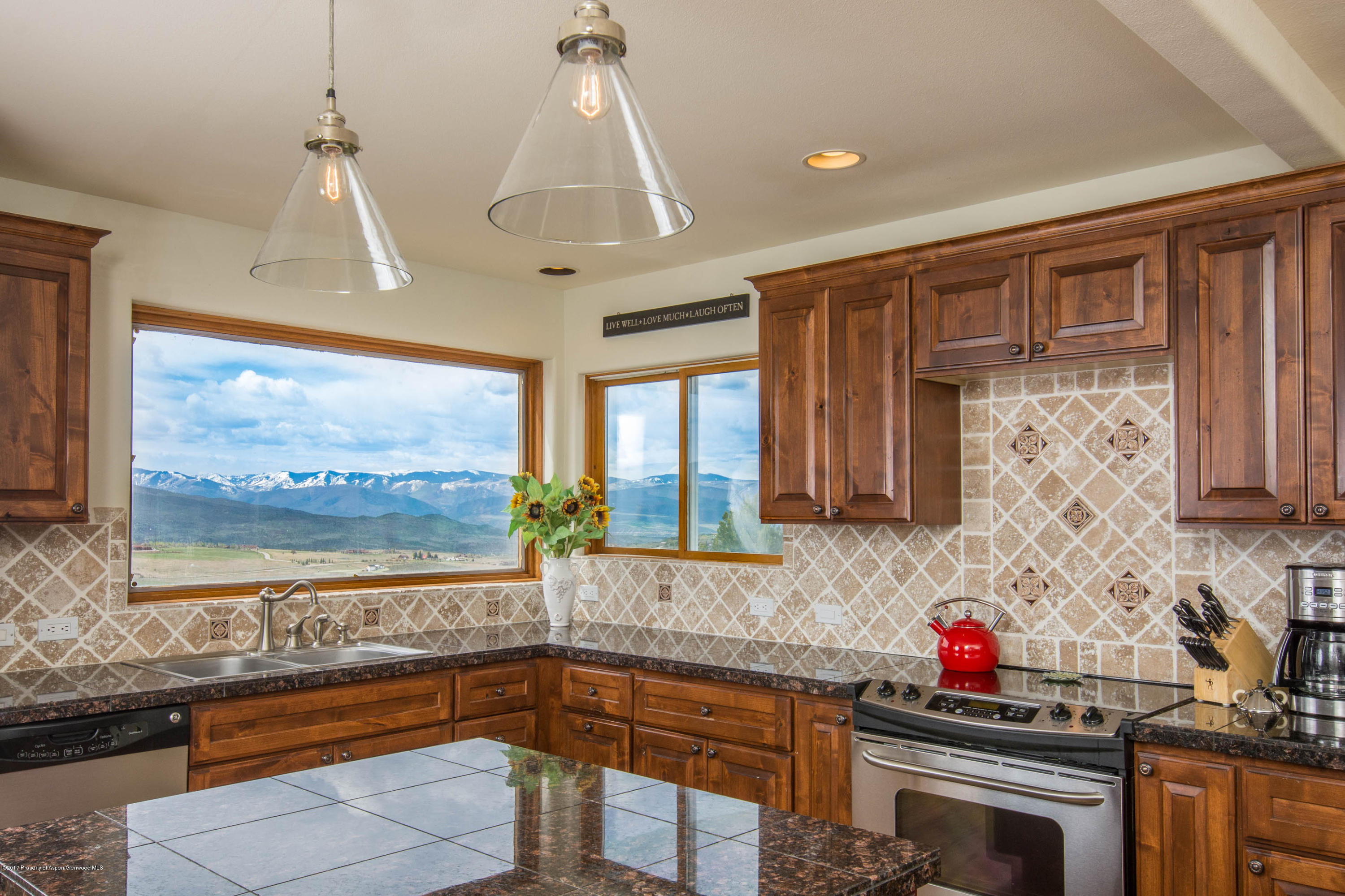 321 Mountain View Road Carbondale, CO 81623 - Photo 7 of 36 a kitchen that has a sink cabinets appliances and a window