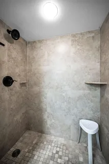 a bathroom with a toilet and a shower