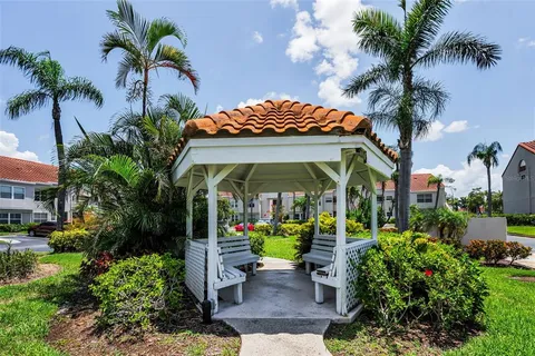 a view of a table and chairs in a patio in front of the house