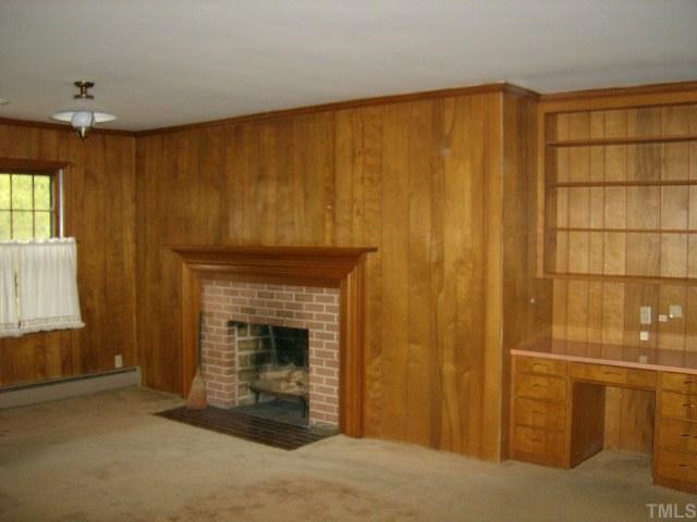 250 Winhaven Street Roxboro, NC 27573 - Photo 7 of 12 Den has paneled walls, carpet and Fireplace