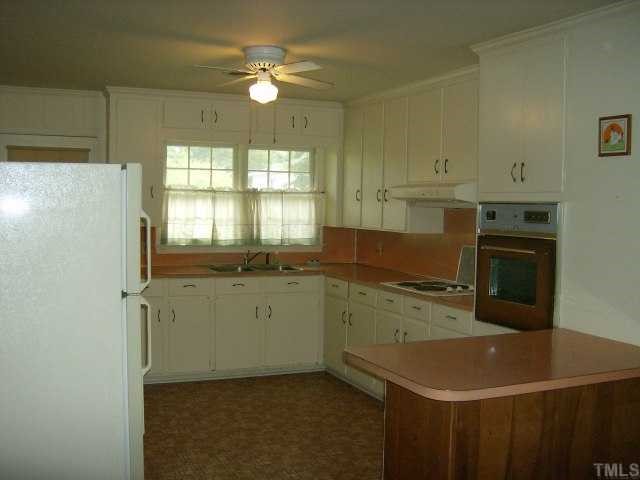 250 Winhaven Street Roxboro, NC 27573 - Photo 10 of 12 Kitchen has eat at bar that seperates the kitchen from the den