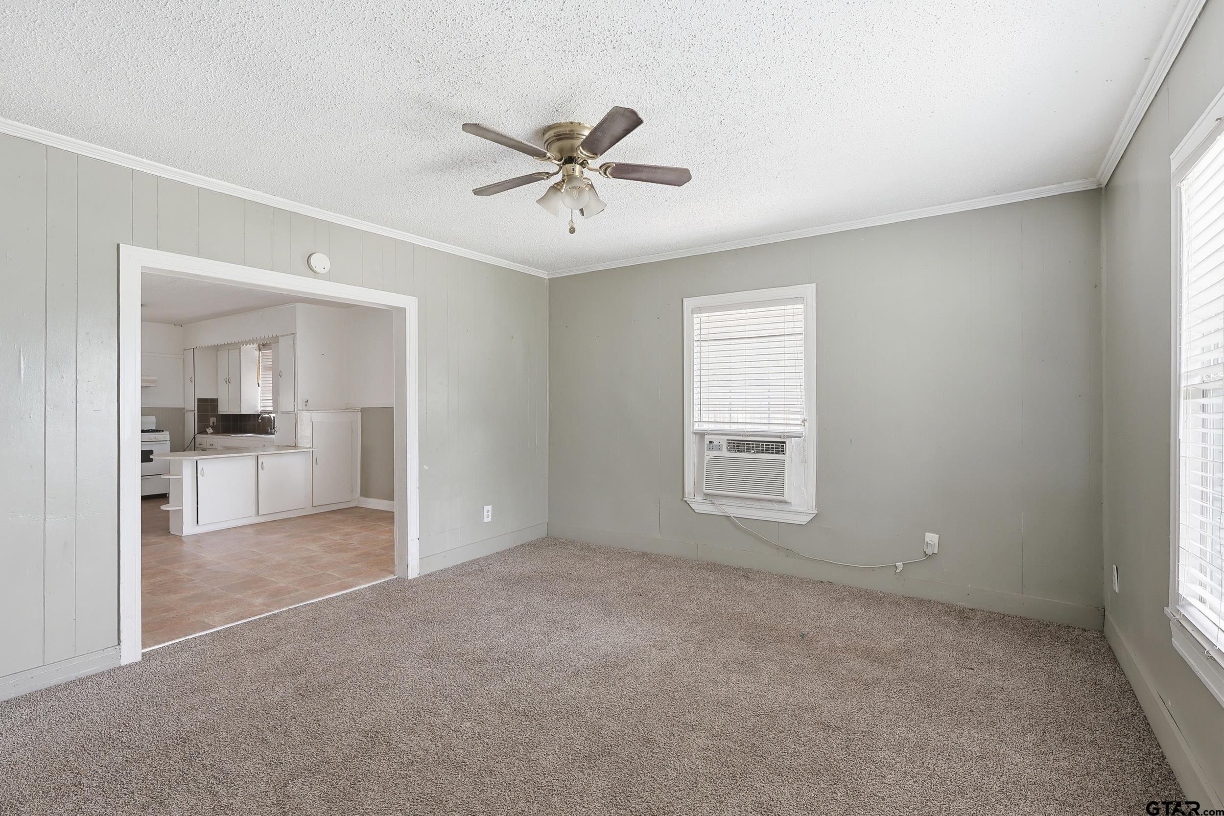 405 Rusk Street Pittsburg, TX 75686 - Photo 11 of 33 a view of a big room with windows and cabinet