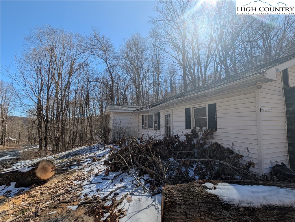 435 Edwards Road West Jefferson, NC 28694 - Photo 8 of 23 a backyard of a house with large trees and wooden fence