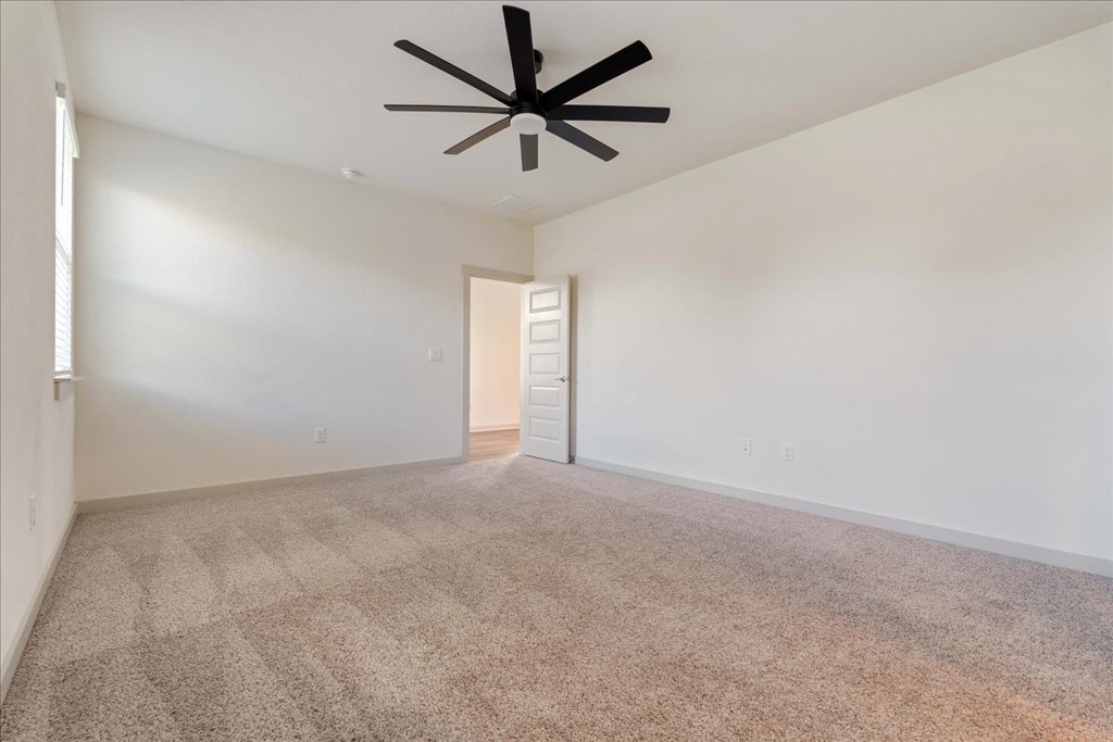 7410 Sagira Path Austin, TX 78724 - Photo 16 of 37 an empty room with a empty space and a ceiling fan