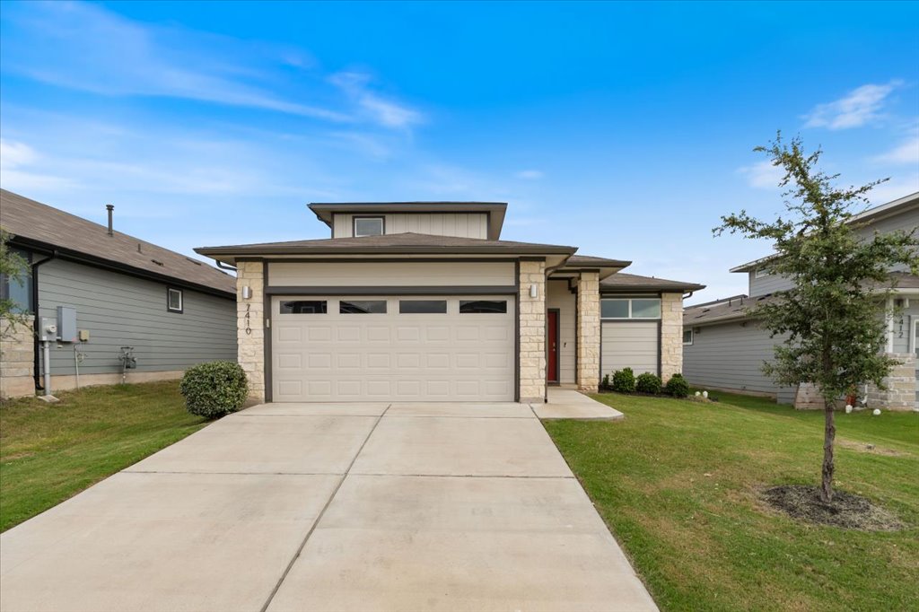 7410 Sagira Path Austin, TX 78724 - Photo 2 of 37 a front view of a house with a yard