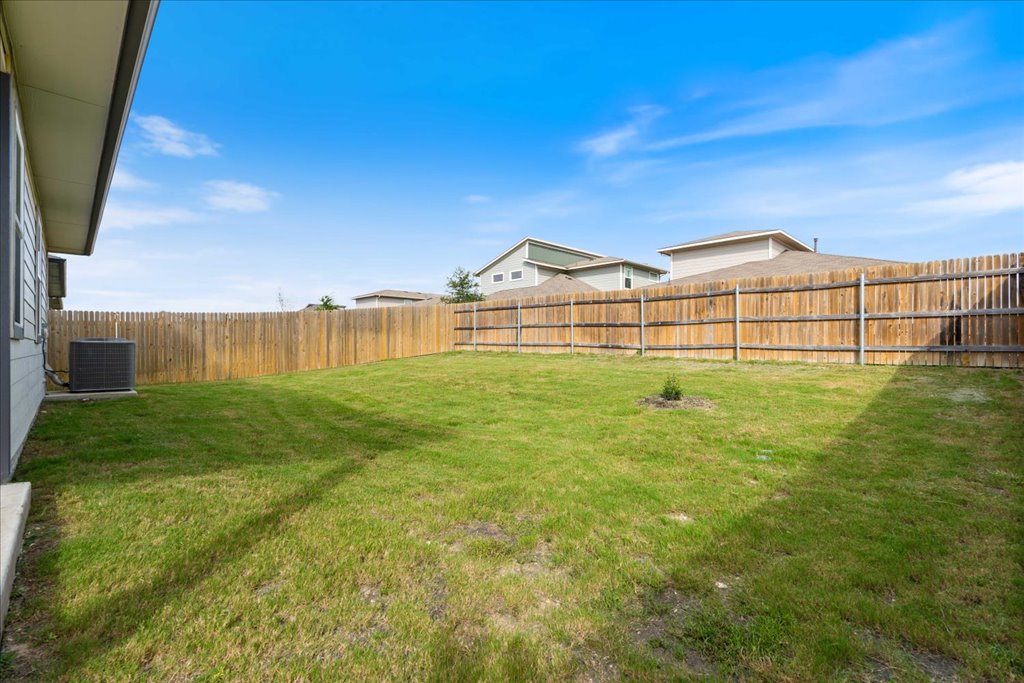 7410 Sagira Path Austin, TX 78724 - Photo 29 of 37 a view of a large garden with large tree and wooden fence
