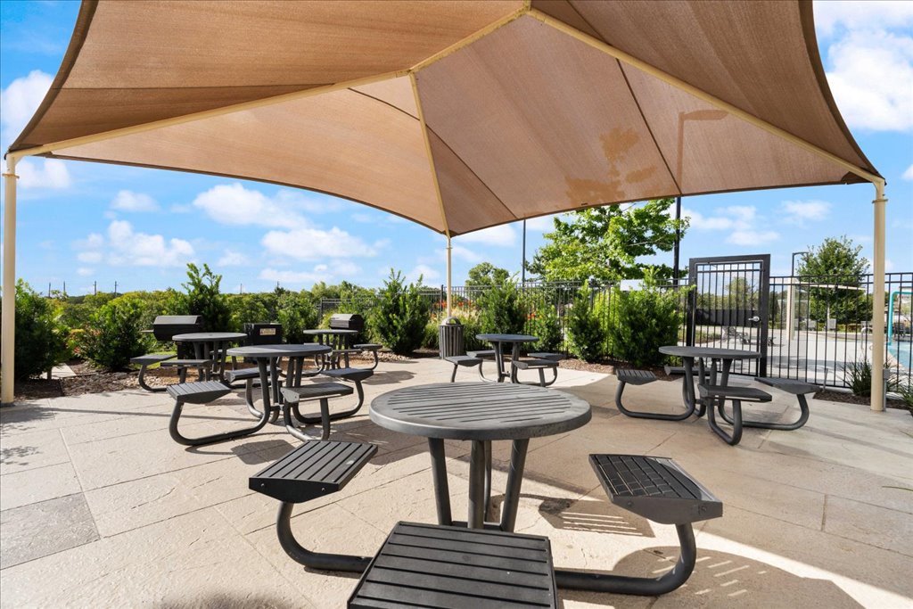 7410 Sagira Path Austin, TX 78724 - Photo 33 of 37 a view of a patio with a table and chairs under an umbrella