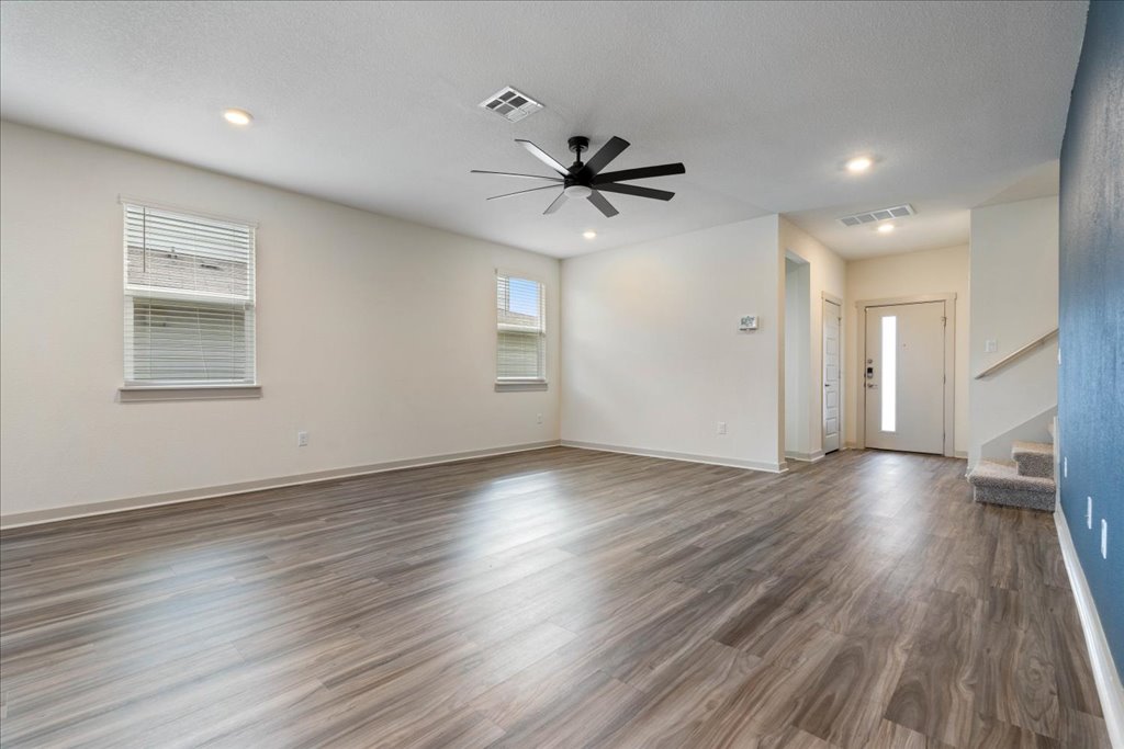 7410 Sagira Path Austin, TX 78724 - Photo 9 of 37 a view of a livingroom with wooden floor and a ceiling fan