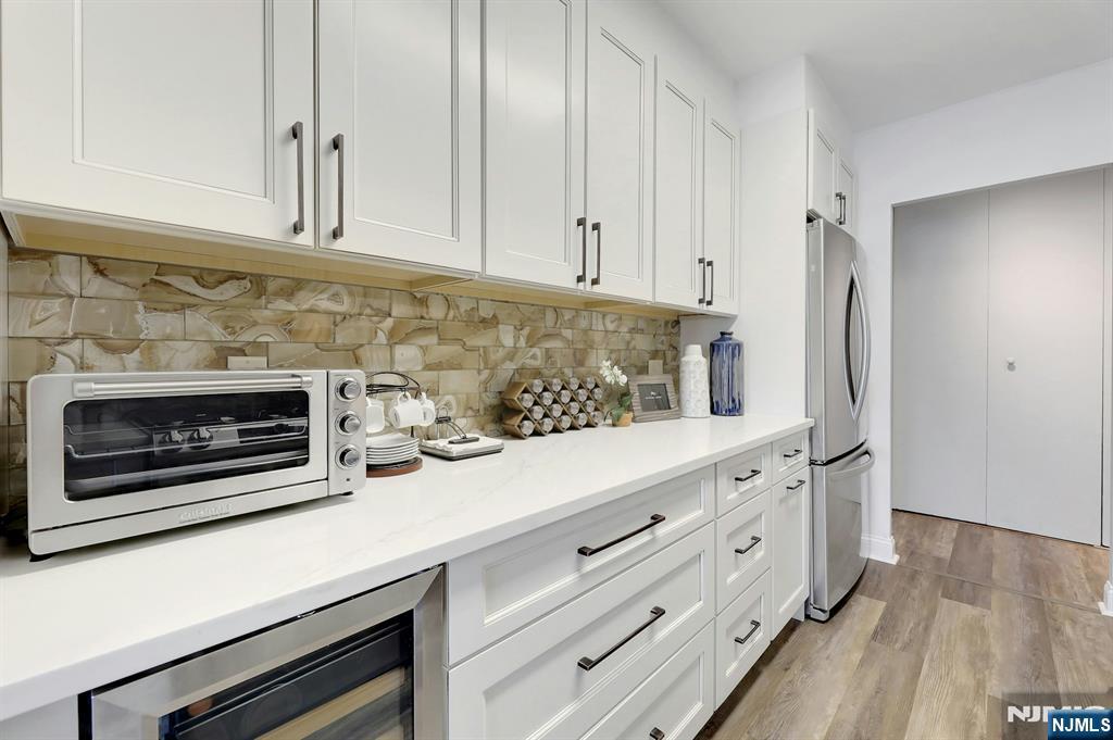 6 Horizon Road, Unit 2209 Fort Lee, NJ 07024 - Photo 12 of 50 a kitchen with granite countertop a stove fireplace and wooden floor
