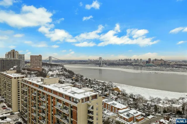 a spacious bedroom with a bed and a flat screen tv