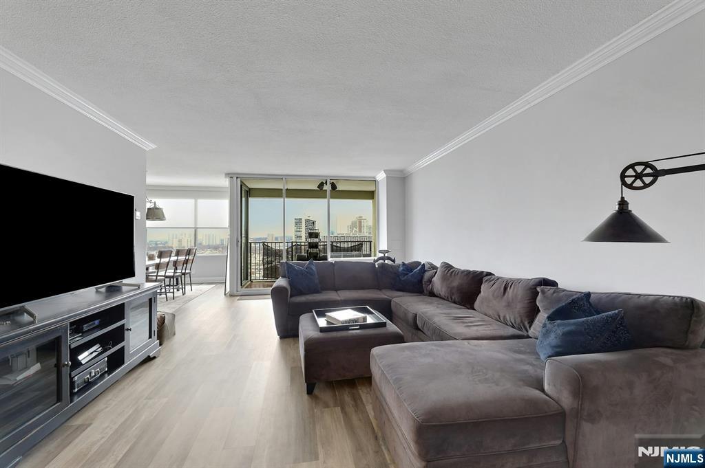 6 Horizon Road, Unit 2209 Fort Lee, NJ 07024 - Photo 21 of 50 a living room with furniture and a flat screen tv