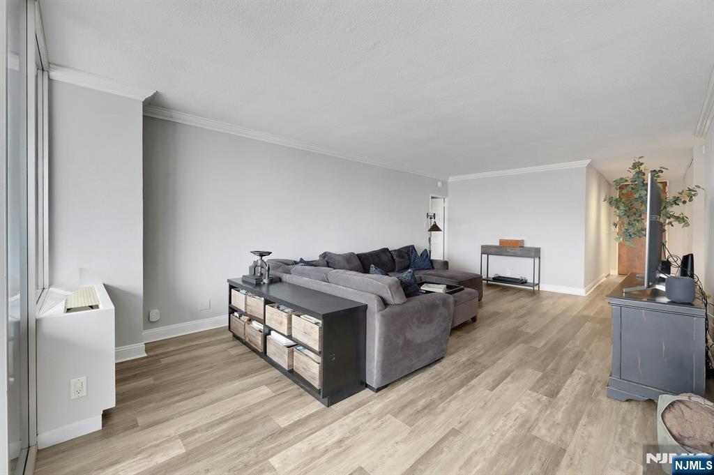 6 Horizon Road, Unit 2209 Fort Lee, NJ 07024 - Photo 24 of 50 a living room with furniture and a flat screen tv