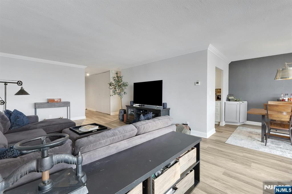 6 Horizon Road, Unit 2209 Fort Lee, NJ 07024 - Photo 25 of 50 a living room with furniture and a flat screen tv