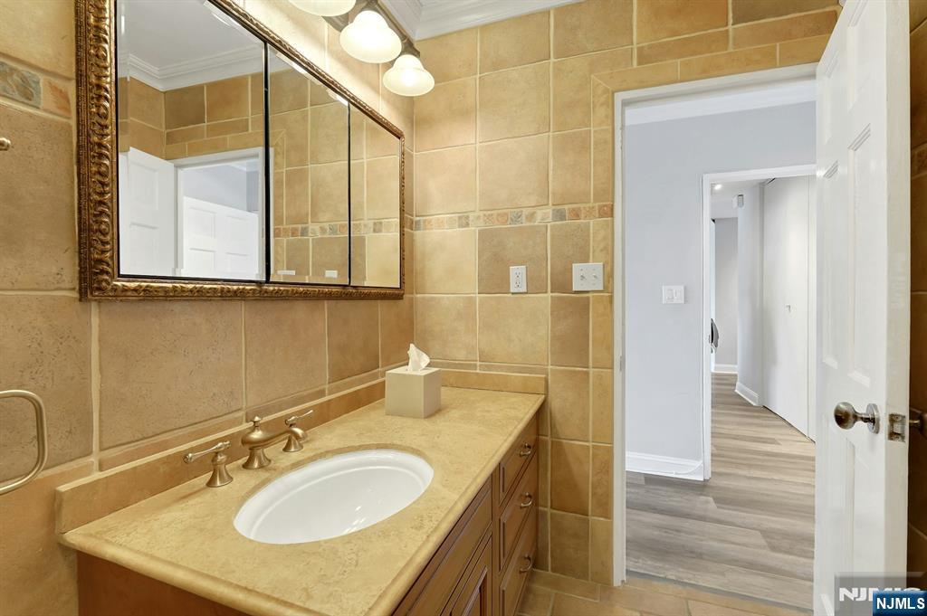 6 Horizon Road, Unit 2209 Fort Lee, NJ 07024 - Photo 32 of 50 a bathroom with a sink and a mirror