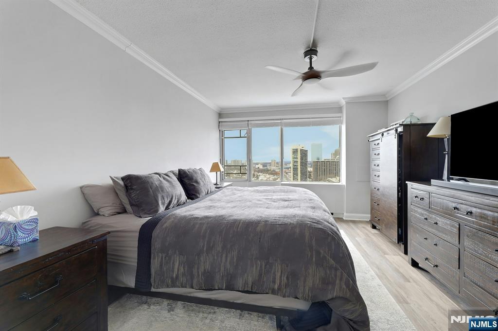 6 Horizon Road, Unit 2209 Fort Lee, NJ 07024 - Photo 34 of 50 a spacious bedroom with a bed and a flat screen tv