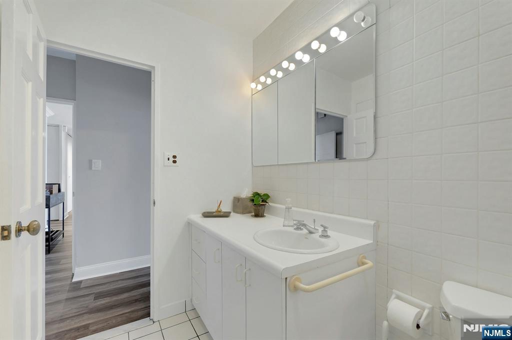 6 Horizon Road, Unit 2209 Fort Lee, NJ 07024 - Photo 37 of 50 a bathroom with a sink a toilet and mirror