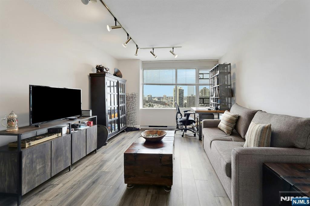 6 Horizon Road, Unit 2209 Fort Lee, NJ 07024 - Photo 42 of 50 a living room with furniture and a flat screen tv