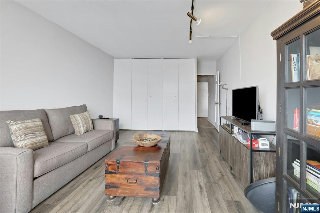 6 Horizon Road, Unit 2209 Fort Lee, NJ 07024 - Photo 43 of 50 a living room with furniture and a flat screen tv