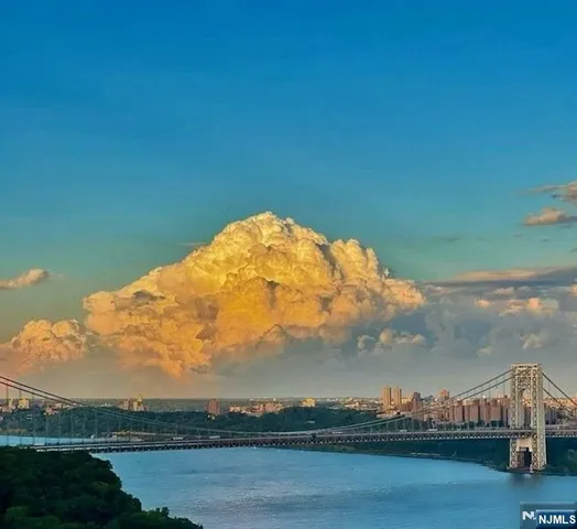 a kitchen with stainless steel appliances a stove a microwave oven cabinets and a sink