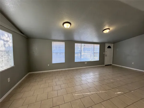 a kitchen with granite countertop a stove a sink and a refrigerator