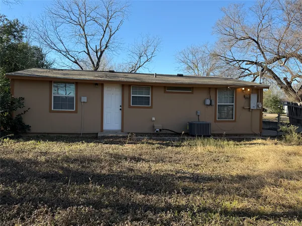 a house that has a tree in front of it