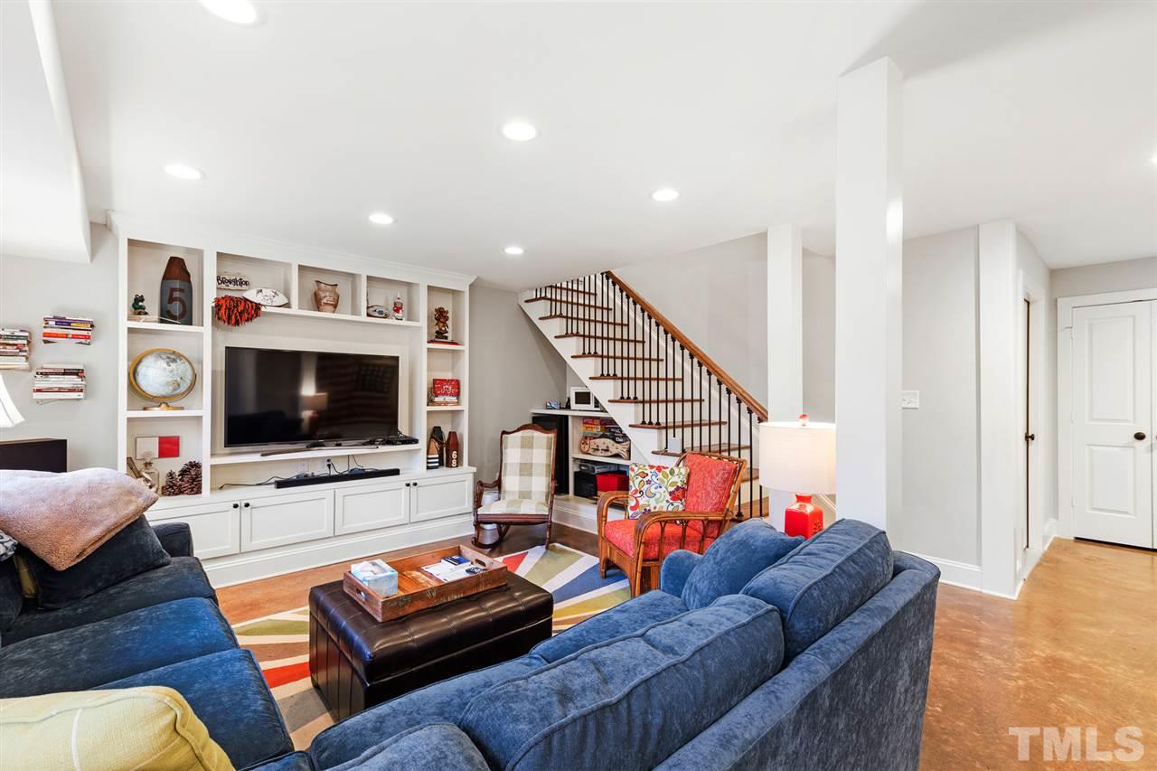 3325 Horton Street Raleigh, NC 27607 - Photo 22 of 30 a living room with furniture and a flat screen tv