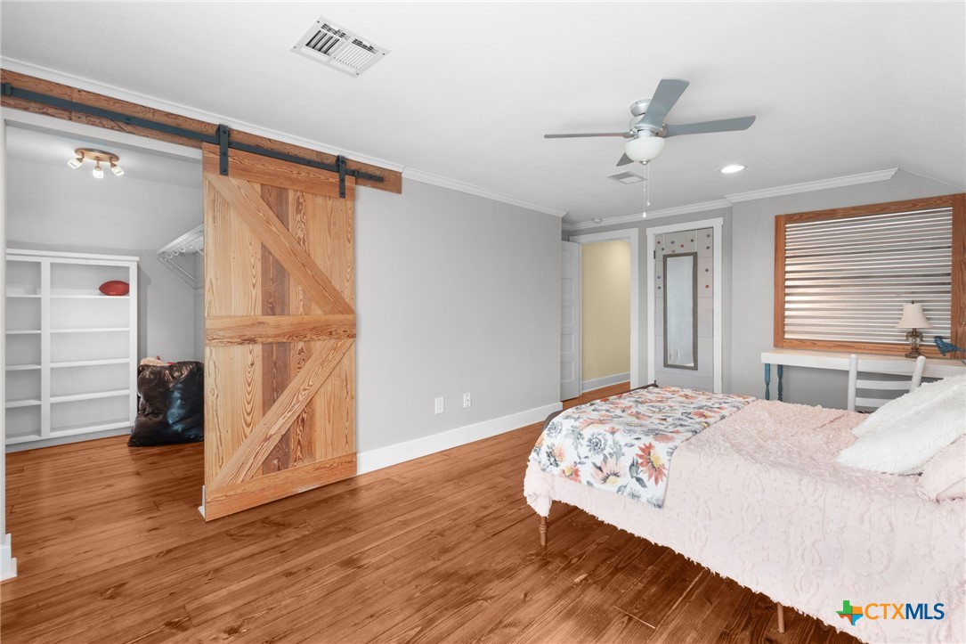 951 Moseley Road Copperas Cove, TX 76522 - Photo 33 of 43 a bedroom with a bed and wooden floor