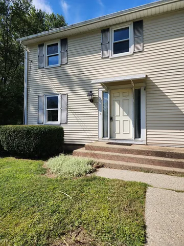 a view of a house with a backyard