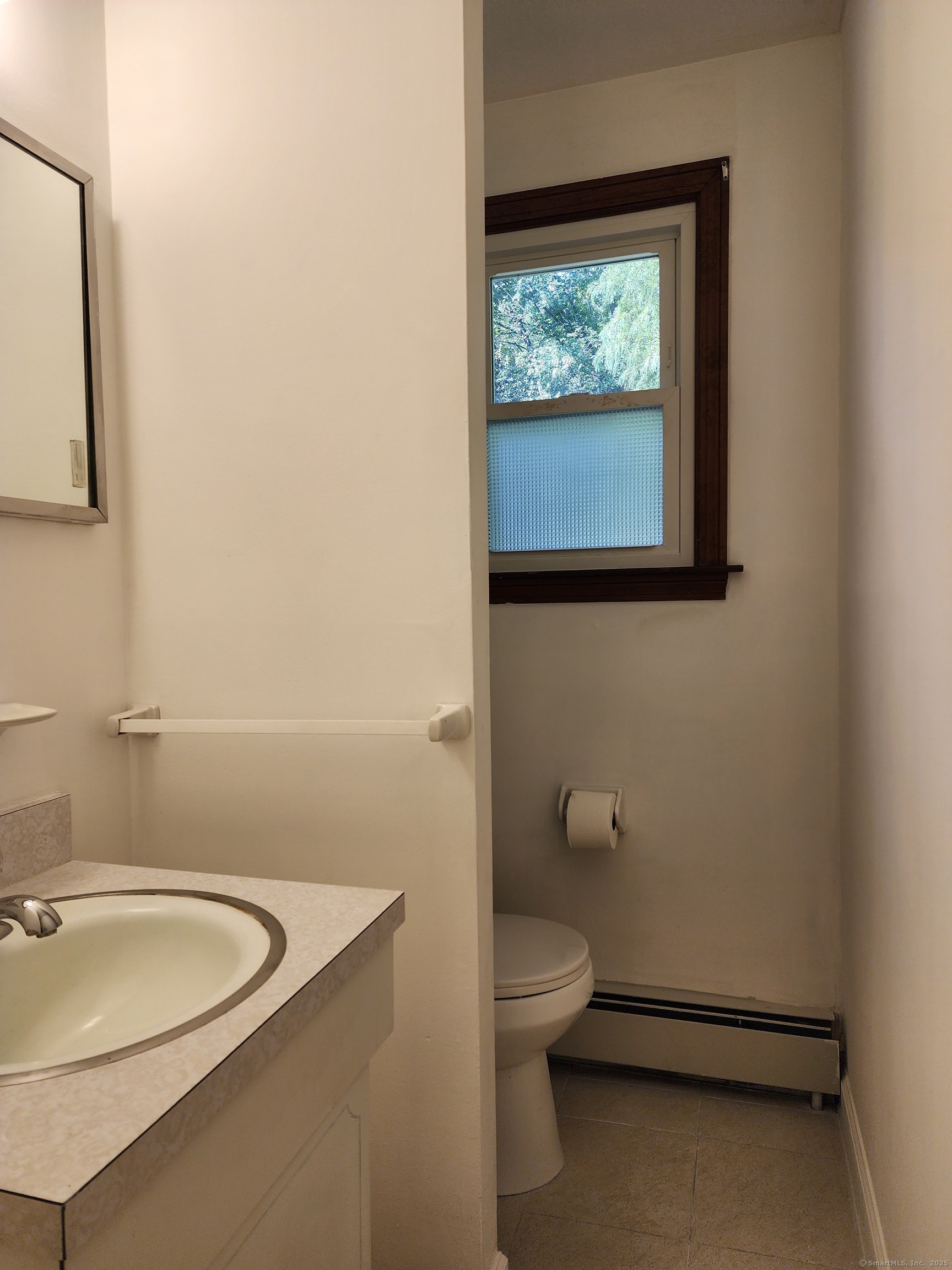 195 Wall Street Hebron, CT 06248 - Photo 5 of 12 a bathroom with a toilet a sink and mirror