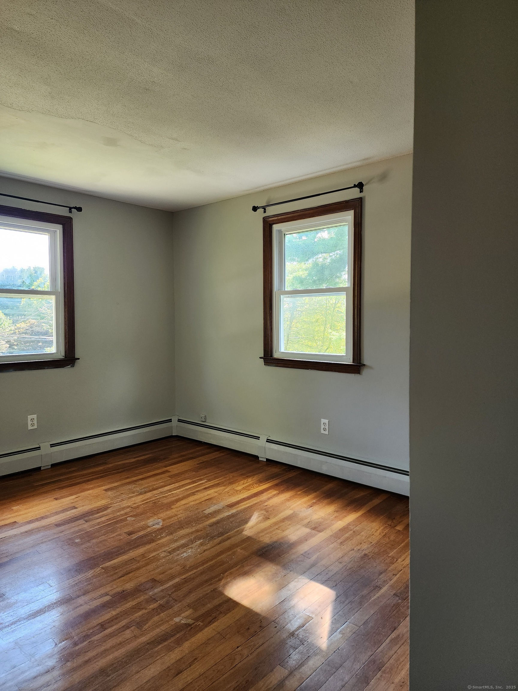 195 Wall Street Hebron, CT 06248 - Photo 10 of 12 an empty room with wooden floor and windows