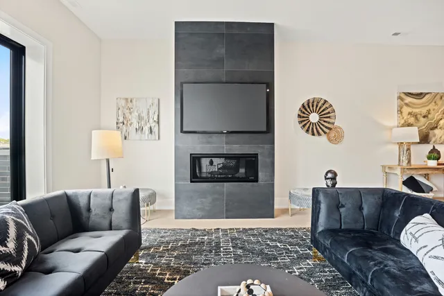 a living room with furniture and a fireplace