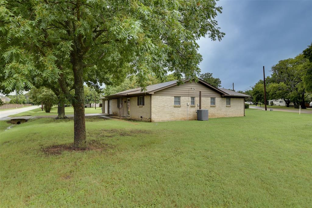 802 Cardinal Road Mansfield, TX 76063 - Photo 3 of 31 View of property exterior with a lawn and brick siding