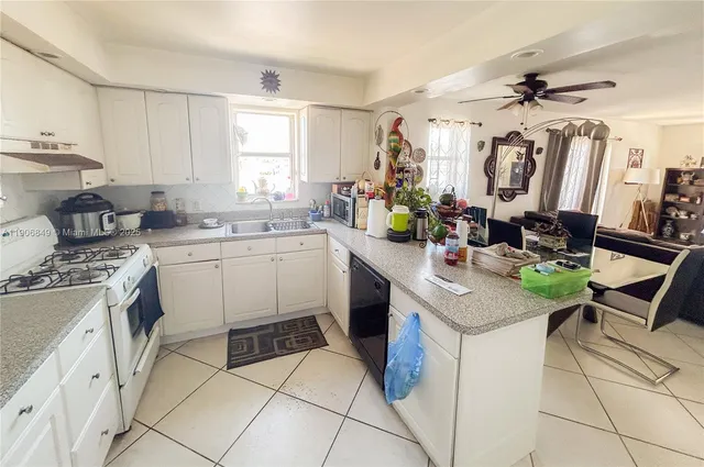 a kitchen that has a sink and a stove in it
