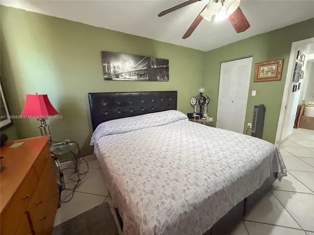 a large bedroom with bed and window