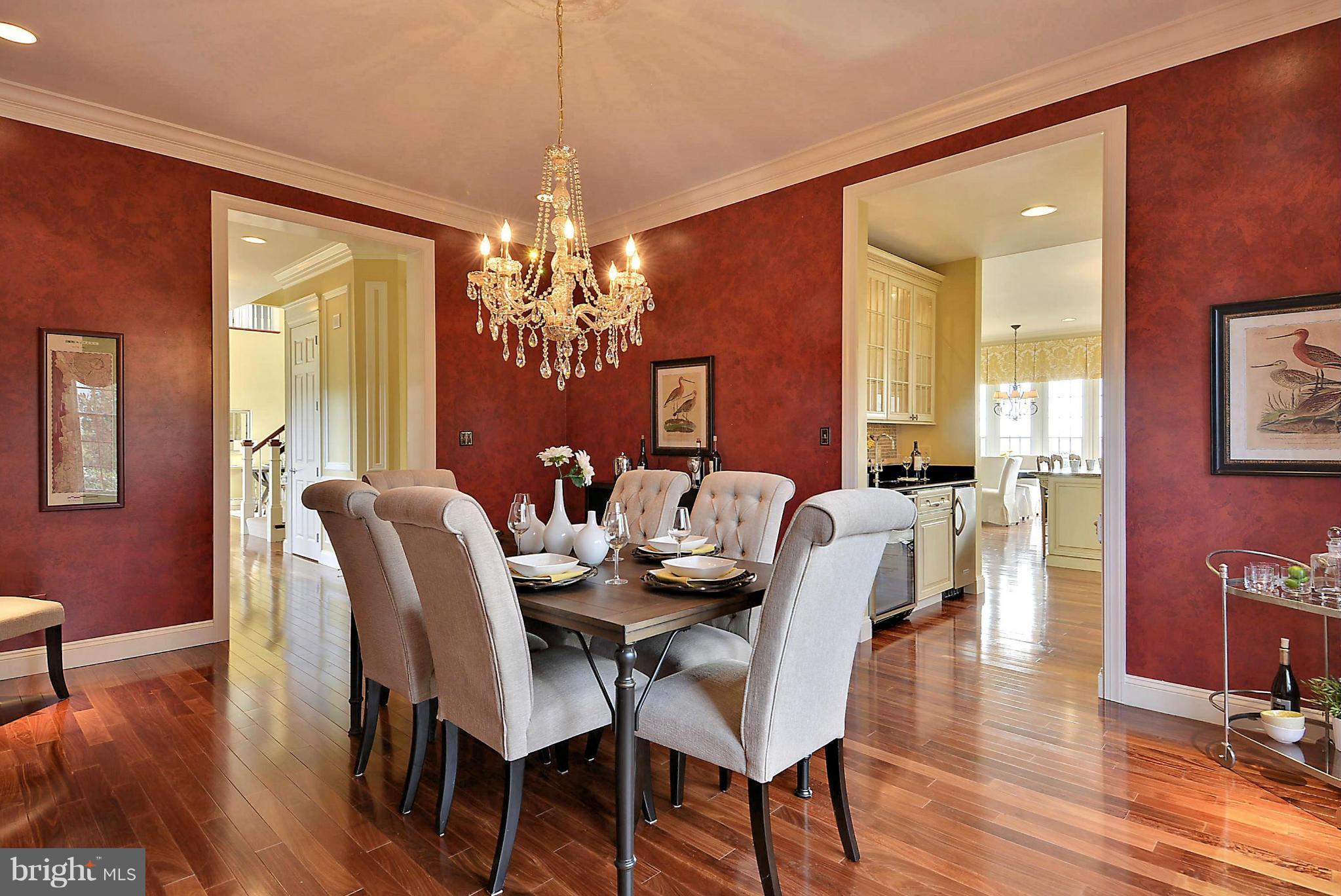 2925 Cox Neck Road East Chester, MD 21619 - Photo 6 of 30 a dining room with furniture a chandelier and wooden floor