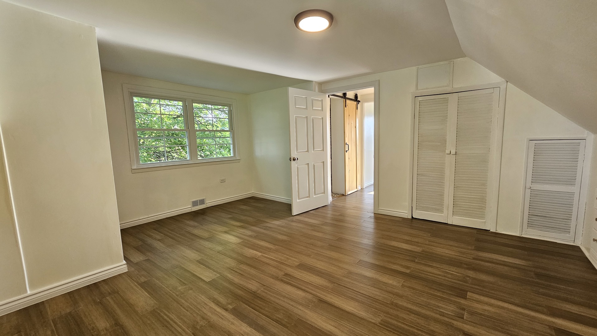 7233 West 85th Street Bridgeview, IL 60455 - Photo 11 of 15 an empty room with wooden floor and windows