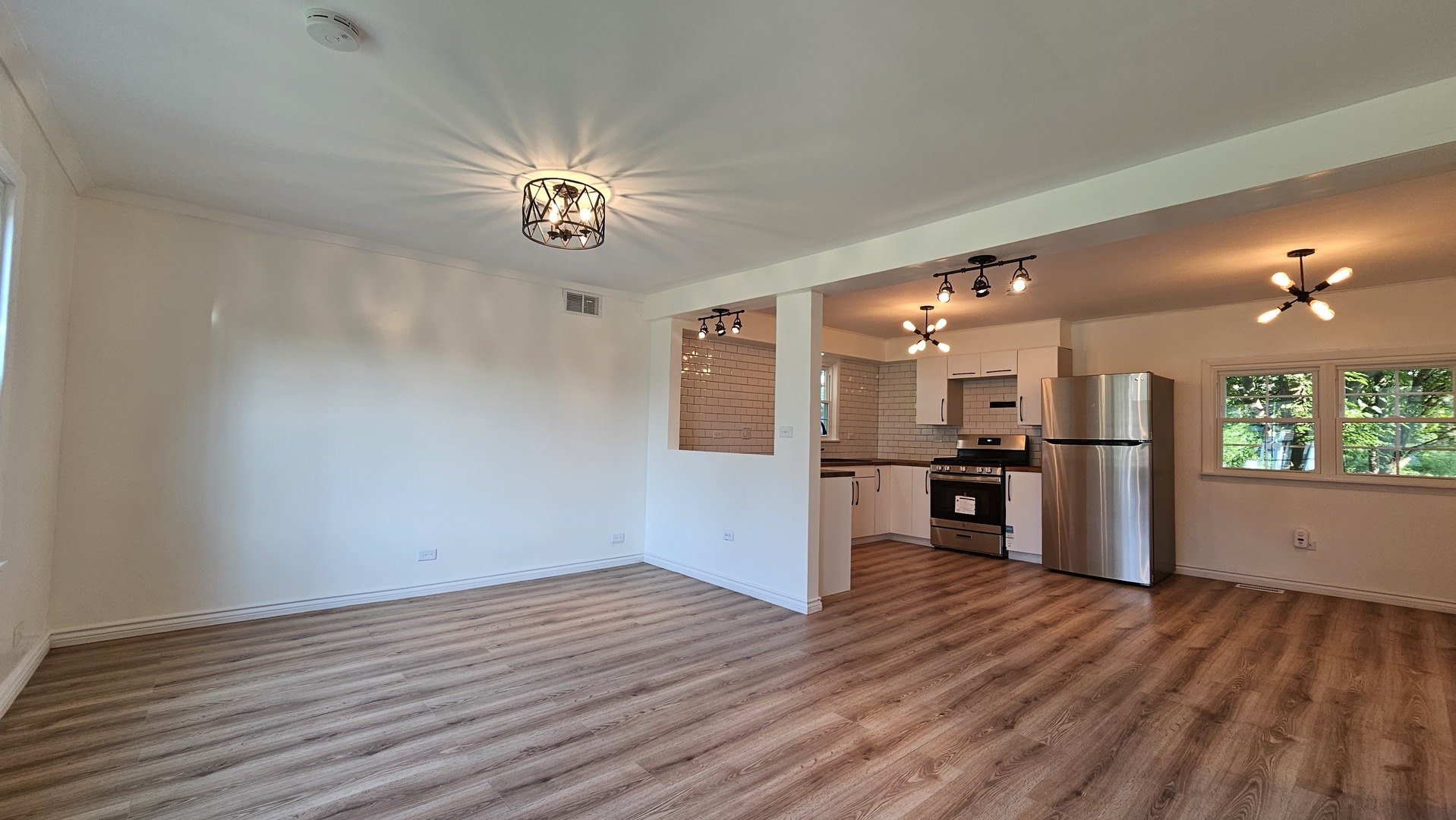 7233 West 85th Street Bridgeview, IL 60455 - Photo 3 of 15 a view of a kitchen with a sink and wooden floor