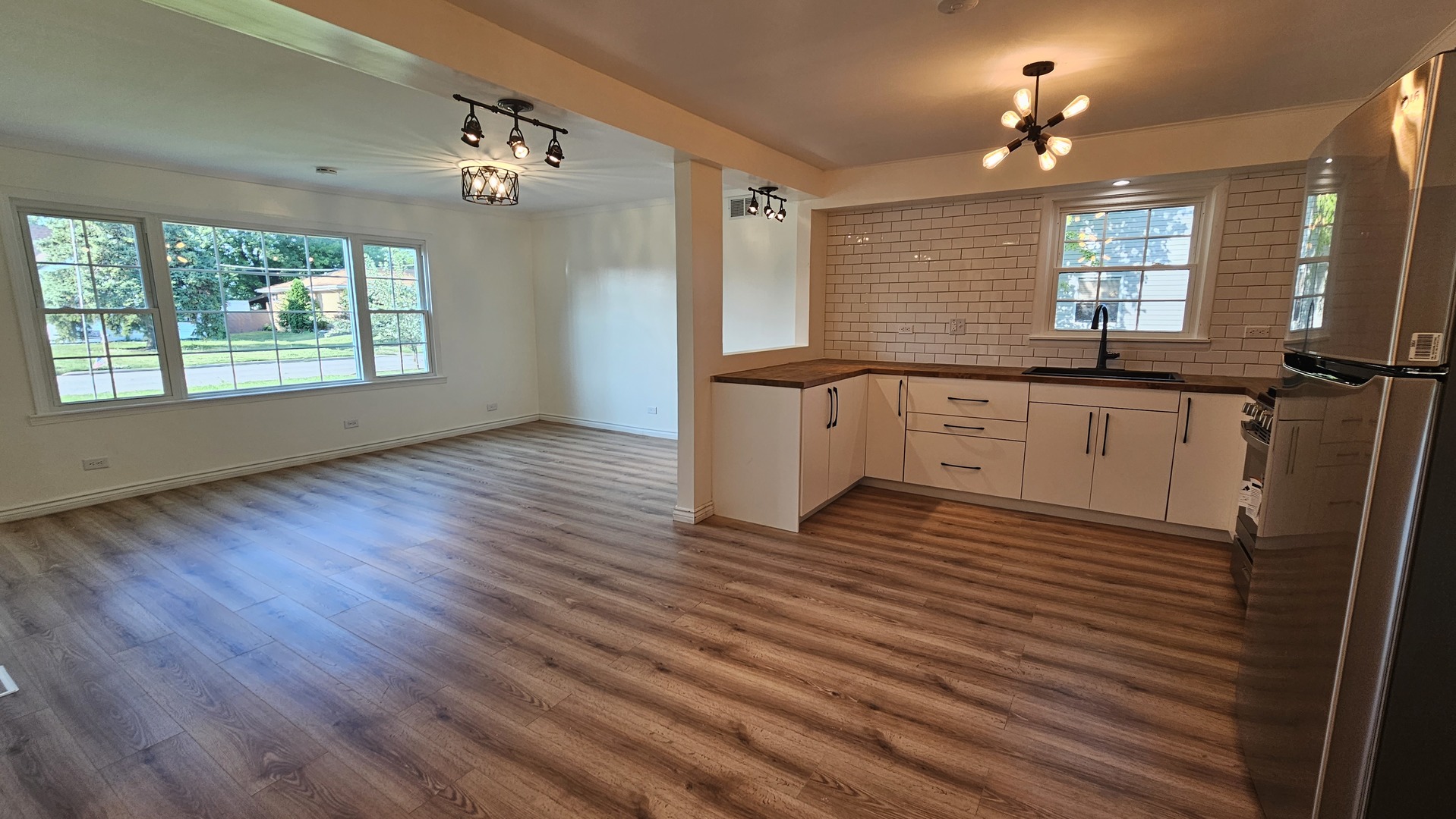 7233 West 85th Street Bridgeview, IL 60455 - Photo 5 of 15 a large kitchen with a wooden floor and a large window