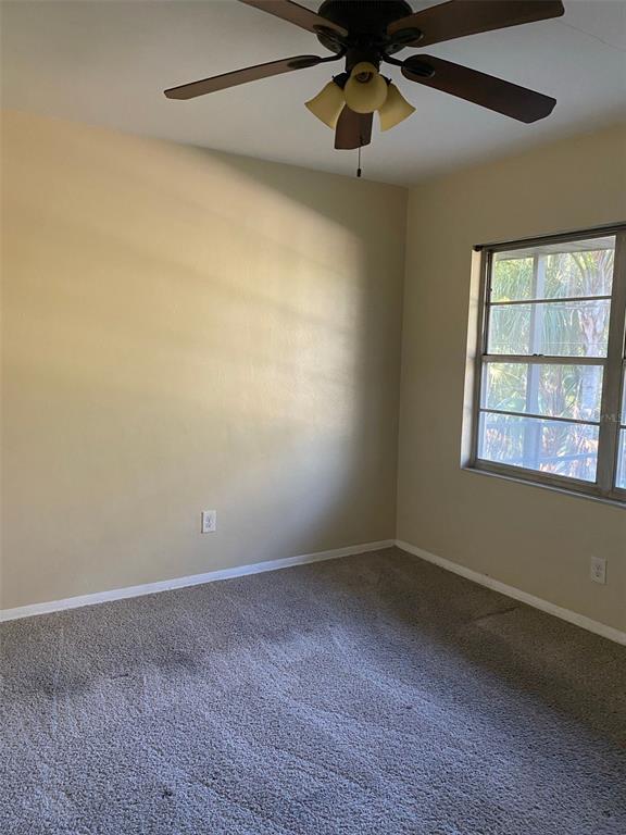 639 Ramona Lane, Unit 8 Orlando, FL 32805 - Photo 6 of 11 an empty room with a window and a fan