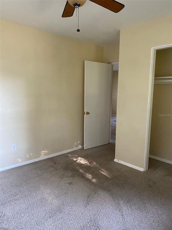 639 Ramona Lane, Unit 8 Orlando, FL 32805 - Photo 10 of 11 an empty room with a ceiling fan and a window