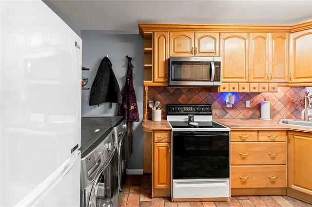 a kitchen with stainless steel appliances granite countertop a stove and a refrigerator