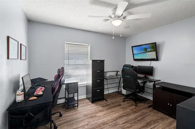 a view of a workspace with furniture and a window