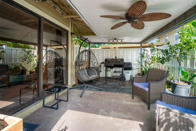 a view of a porch with furniture and a yard