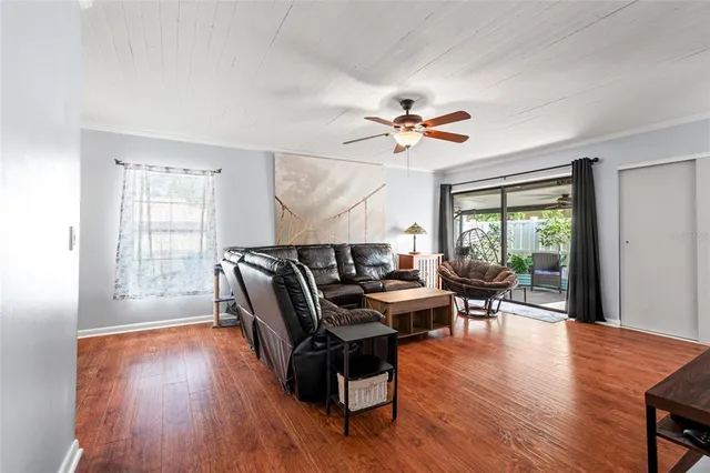 a work room with furniture wooden floor and a window